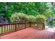 Wooden deck overlooking a lush backyard with mature trees and landscaping at 6104 New Market Way, Raleigh, NC 27609