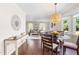 Charming dining room with hardwood floors, stylish lighting, and seamless access to the living room and kitchen at 6104 New Market Way, Raleigh, NC 27609