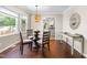 Inviting dining area with natural light, modern lighting, and a view into the kitchen creating an ideal space at 6104 New Market Way, Raleigh, NC 27609