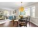 Open-concept dining area features hardwood floors, modern lighting, and a seamless transition into the living space at 6104 New Market Way, Raleigh, NC 27609