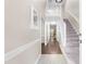 Bright foyer features hardwood floors, high ceilings, stairs leading to the upper level, and a view to the living room at 6104 New Market Way, Raleigh, NC 27609