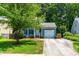 Inviting home featuring a well-kept lawn, an attached garage, and a welcoming entrance enhancing its curb appeal at 6104 New Market Way, Raleigh, NC 27609