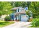 Charming two-story home with a well-manicured lawn, an attached garage, and classic curb appeal at 6104 New Market Way, Raleigh, NC 27609