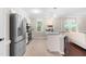 Well-lit kitchen featuring stainless steel appliances, granite countertops, a breakfast bar, and hardwood floors at 6104 New Market Way, Raleigh, NC 27609