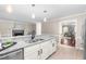 Open-concept kitchen with granite counters and stainless steel appliances, connecting to the living area with a fireplace at 6104 New Market Way, Raleigh, NC 27609