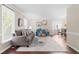 Bright living room features hardwood floors, neutral paint, large windows, and an open layout at 6104 New Market Way, Raleigh, NC 27609