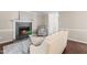 A comfortable living room is centered around a fireplace with decor at 6104 New Market Way, Raleigh, NC 27609