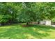 Expansive backyard features mature trees, a trampoline, and a storage shed, offering ample outdoor space at 7009 Brecken Ridge Ave, Raleigh, NC 27615