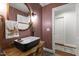 Stylish half bathroom with vessel sink, unique mirror, and an arched doorway for an elevated feel at 7009 Brecken Ridge Ave, Raleigh, NC 27615