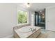The beautiful bathroom features a jacuzzi bathtub and glass enclosed shower with views of the trees at 7009 Brecken Ridge Ave, Raleigh, NC 27615