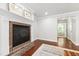 Cozy fireplace in bedroom with hardwood flooring and a glimpse of a luxurious bathroom at 7009 Brecken Ridge Ave, Raleigh, NC 27615