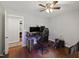 Hardwood floor bedroom featuring ceiling fan and desk for gaming setup, creating a comfortable and functional space at 7009 Brecken Ridge Ave, Raleigh, NC 27615