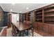 Formal dining room boasts beautiful built-in shelving, hardwood floors, and glass French doors at 7009 Brecken Ridge Ave, Raleigh, NC 27615