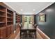 Dining area with custom cabinetry, wood floors, and oversized window views at 7009 Brecken Ridge Ave, Raleigh, NC 27615