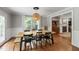 Bright dining room featuring wood table, floors, and large windows at 7009 Brecken Ridge Ave, Raleigh, NC 27615