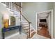 Welcoming foyer with a staircase, console table, and view into the adjacent living area at 7009 Brecken Ridge Ave, Raleigh, NC 27615