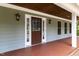 Inviting front porch with classic lighting fixtures, offering a warm welcome to guests at 7009 Brecken Ridge Ave, Raleigh, NC 27615