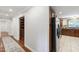Hallway view into kitchen with pantry and stainless refrigerator on display at 7009 Brecken Ridge Ave, Raleigh, NC 27615