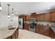Kitchen features granite countertops, stainless appliances, and tile floors at 7009 Brecken Ridge Ave, Raleigh, NC 27615