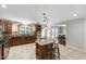 Open kitchen layout with granite countertops, stainless appliances, and island seating at 7009 Brecken Ridge Ave, Raleigh, NC 27615