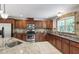 Well-lit kitchen featuring stone backsplash, granite counters, and stainless appliances at 7009 Brecken Ridge Ave, Raleigh, NC 27615