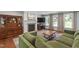 Inviting living area with a brick fireplace, built-in shelves, and a view of the backyard at 7009 Brecken Ridge Ave, Raleigh, NC 27615