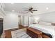Main bedroom with hardwood floors, a ceiling fan, and a cedar chest at the foot of the bed at 7009 Brecken Ridge Ave, Raleigh, NC 27615