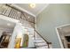 Bright foyer with a staircase with white risers and wood treads leading to the upper level at 7009 Brecken Ridge Ave, Raleigh, NC 27615