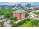 Stunning aerial view of a red brick apartment building with cityscape backdrop and mature landscaping at 710 Independence Pl # 301, Raleigh, NC 27603