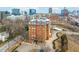 Aerial view of a stately brick building with manicured grounds in a bustling city at 710 Independence Pl # 301, Raleigh, NC 27603