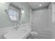 Charming bathroom featuring a pedestal sink, black and white tiled floors, and a tub-shower combo at 710 Independence Pl # 301, Raleigh, NC 27603