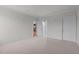 Comfortable bedroom with neutral carpet, painted walls, access to kitchen, and open doorway with closet space at 710 Independence Pl # 301, Raleigh, NC 27603