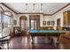 Game room with a pool table, wood trim, large windows and custom lighting at 710 Independence Pl # 301, Raleigh, NC 27603