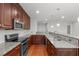 Modern kitchen featuring granite countertops, stainless steel appliances, and wooden cabinets with stylish hardware at 710 Independence Pl # 301, Raleigh, NC 27603