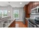 Contemporary kitchen with stainless appliances, granite countertops, hardwood floors, and bright natural lighting at 710 Independence Pl # 301, Raleigh, NC 27603