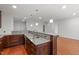 Open-concept living space featuring hardwood floors, granite countertops, kitchen features, and ample natural light at 710 Independence Pl # 301, Raleigh, NC 27603