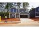 Two-story home showcases a welcoming front porch, spacious driveway, and a well-lit facade at 721 Deschutes Dr, Garner, NC 27529