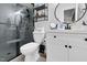 Modern bathroom featuring a glass shower, updated vanity, and round mirror at 7365 Sandy Creek Dr, Raleigh, NC 27615
