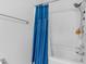 Clean bathroom with a blue shower curtain and shower head at 7365 Sandy Creek Dr, Raleigh, NC 27615