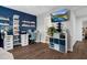Well-lit bonus room with a dedicated workspace, floating shelves, and a view of the bathroom at 7365 Sandy Creek Dr, Raleigh, NC 27615