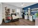 Versatile bonus room with an electric recliner and an expansive workstation and display shelving at 7365 Sandy Creek Dr, Raleigh, NC 27615