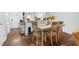 The spacious dining room has a long table with seating for six and hardwood floors at 7365 Sandy Creek Dr, Raleigh, NC 27615