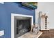 Close up of a fireplace with a white trim and logs inside at 7365 Sandy Creek Dr, Raleigh, NC 27615