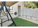 Relaxing front porch featuring a swing, artificial turf, and a pathway with garden lights at 7365 Sandy Creek Dr, Raleigh, NC 27615