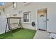 Inviting front porch with cozy swing and artificial turf at 7365 Sandy Creek Dr, Raleigh, NC 27615