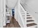 The hallway with hardwood floors leads into the living room and staircase at 7365 Sandy Creek Dr, Raleigh, NC 27615