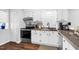 Well-lit kitchen with stainless steel appliances and ample cabinet space at 7365 Sandy Creek Dr, Raleigh, NC 27615