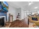 Open-concept living room featuring hardwood floors, a fireplace, and ample natural light at 7365 Sandy Creek Dr, Raleigh, NC 27615