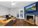 Cozy living room features a fireplace, mounted television, and sliding glass door to outside at 7365 Sandy Creek Dr, Raleigh, NC 27615