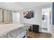 Bright main bedroom with wood-look floors, television, and an ensuite bathroom at 7365 Sandy Creek Dr, Raleigh, NC 27615